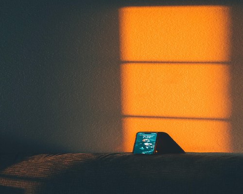 Close up of a smartphone screen with warm color filter activated during evening